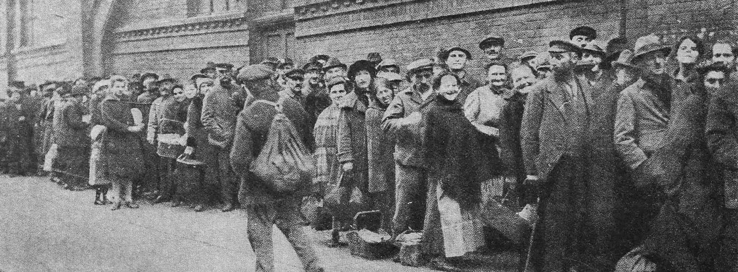 People queueing outside a Berlin bakery in 1923, during the Weimar hyperinflation, when bread prices could rise while they waited