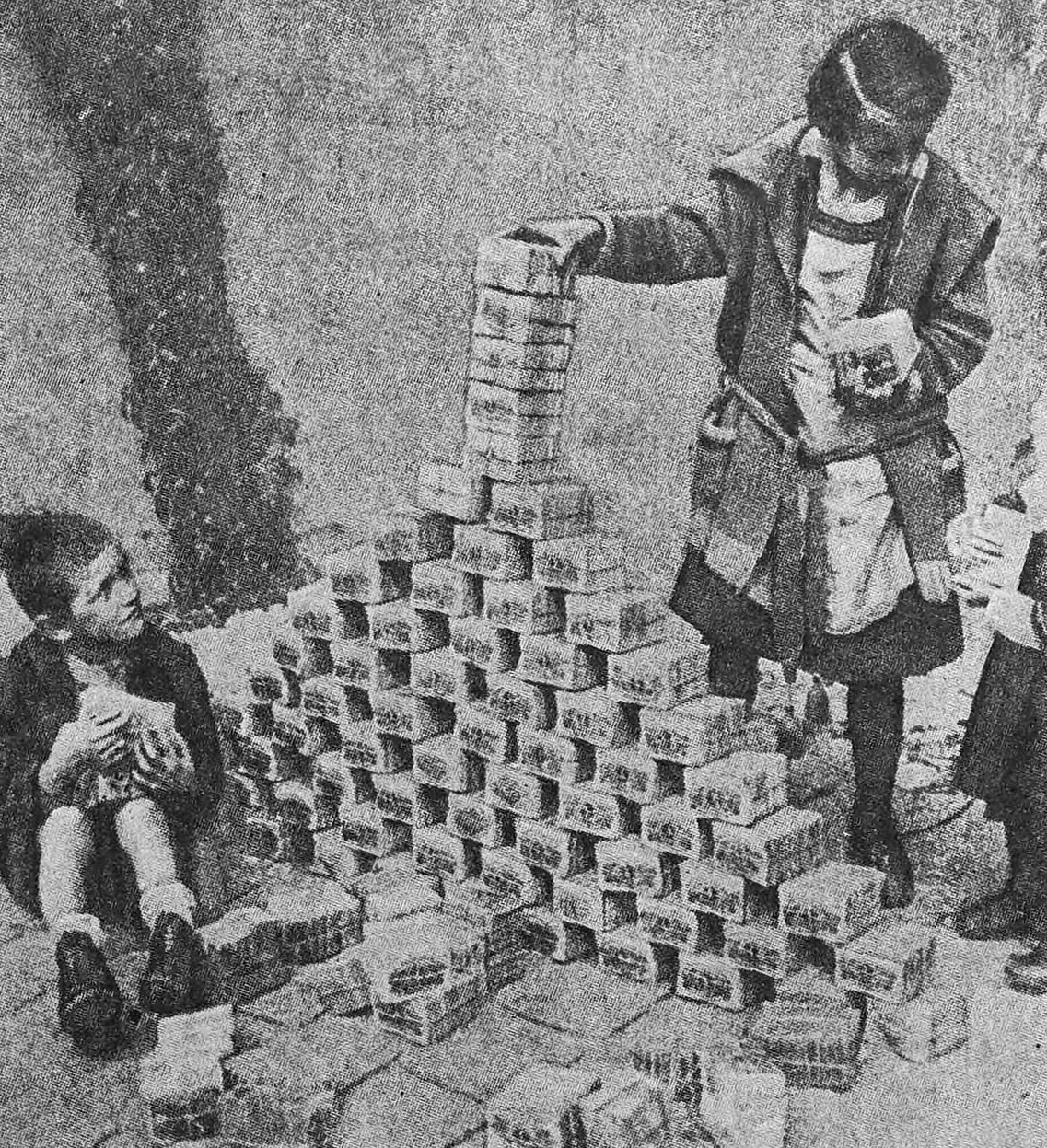German children in 1923 building towers out of bundles of nearly worthless banknotes